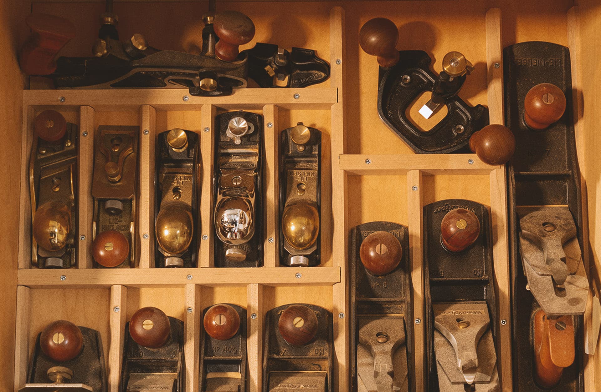 A wall rack of hand planes in Rick Feldman's shop